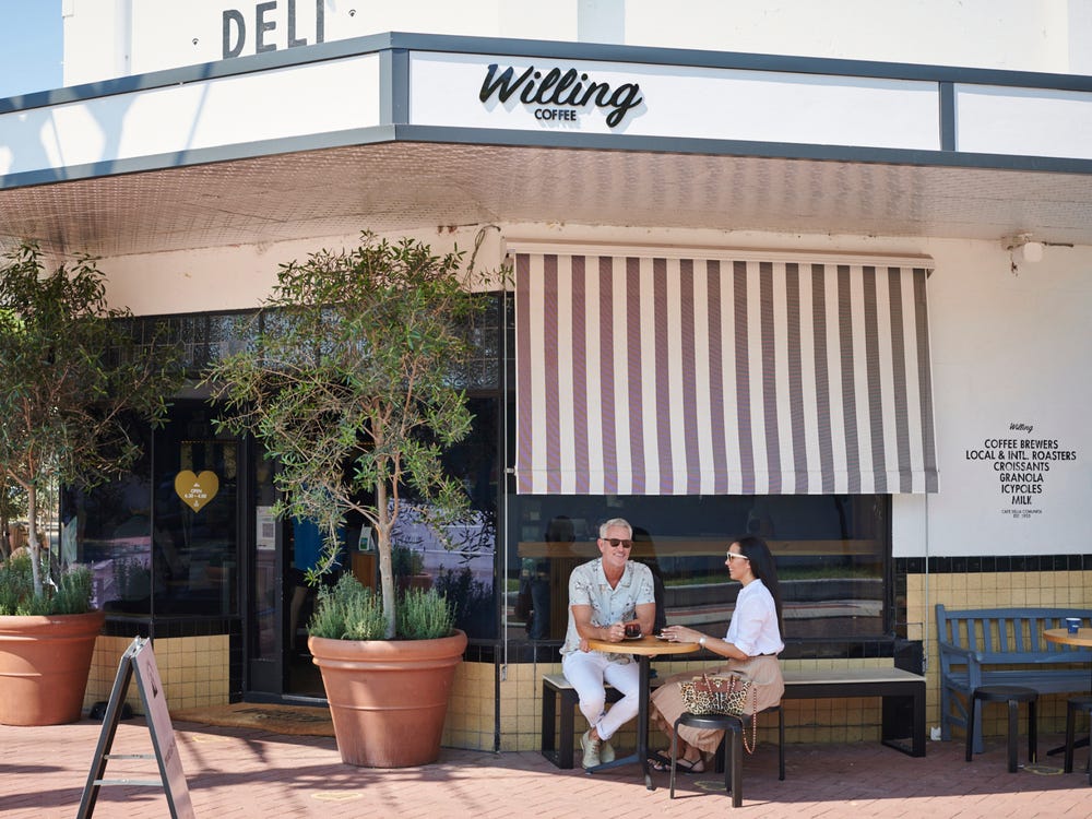 A couple enjoying an alfresco coffee outside Willing Coffee in Mount Lawley