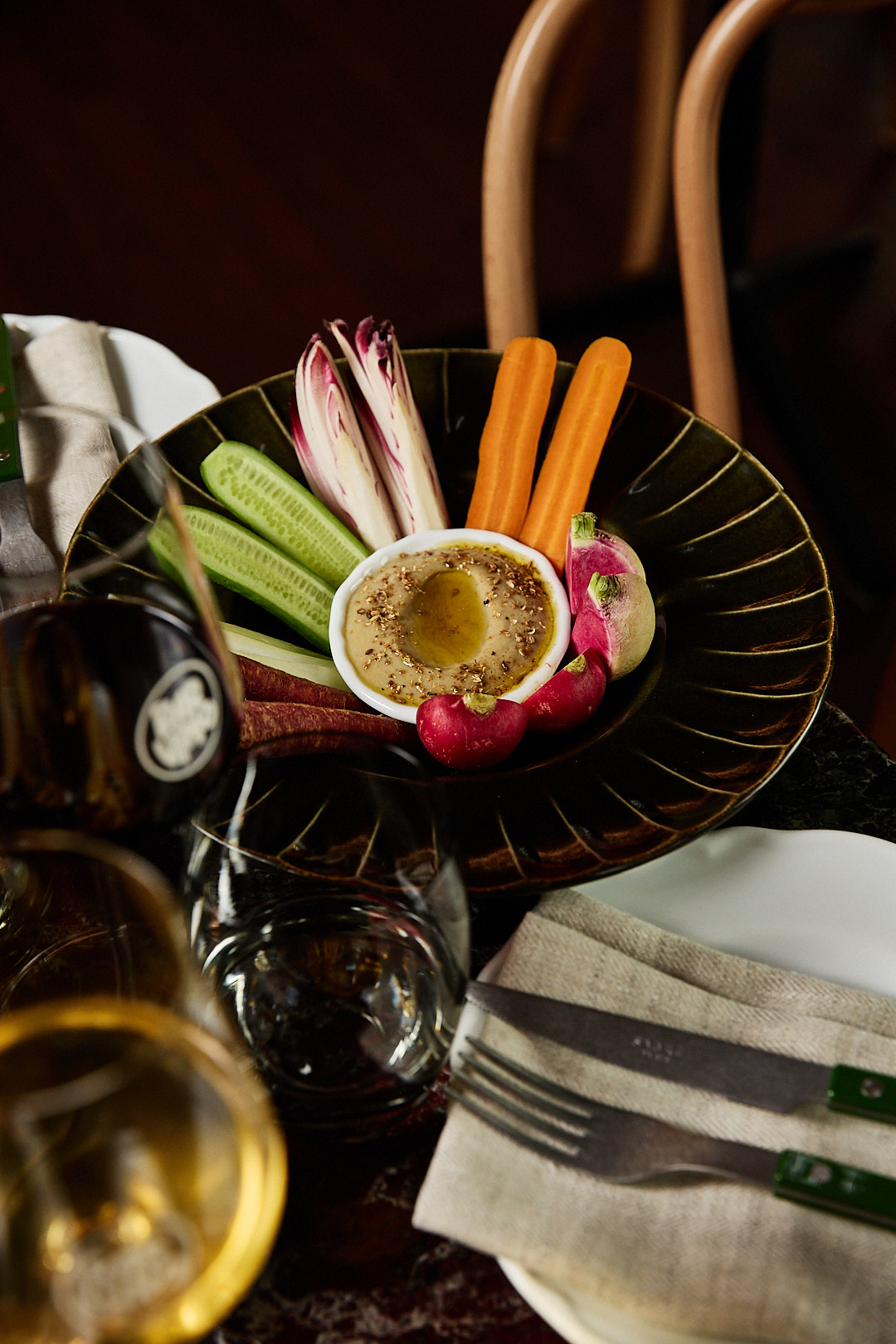 A bar snack at Bar Vino in Mount Lawley, with a glass of red and white wine in the foreground.