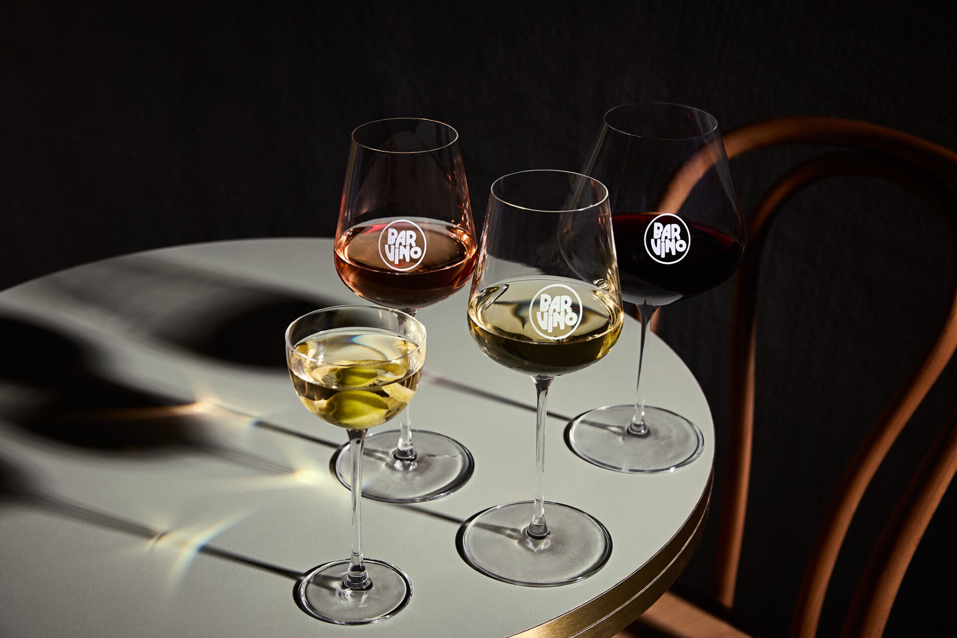 Image of 4 glasses of dramatically lit wines on a table at Bar Vino.