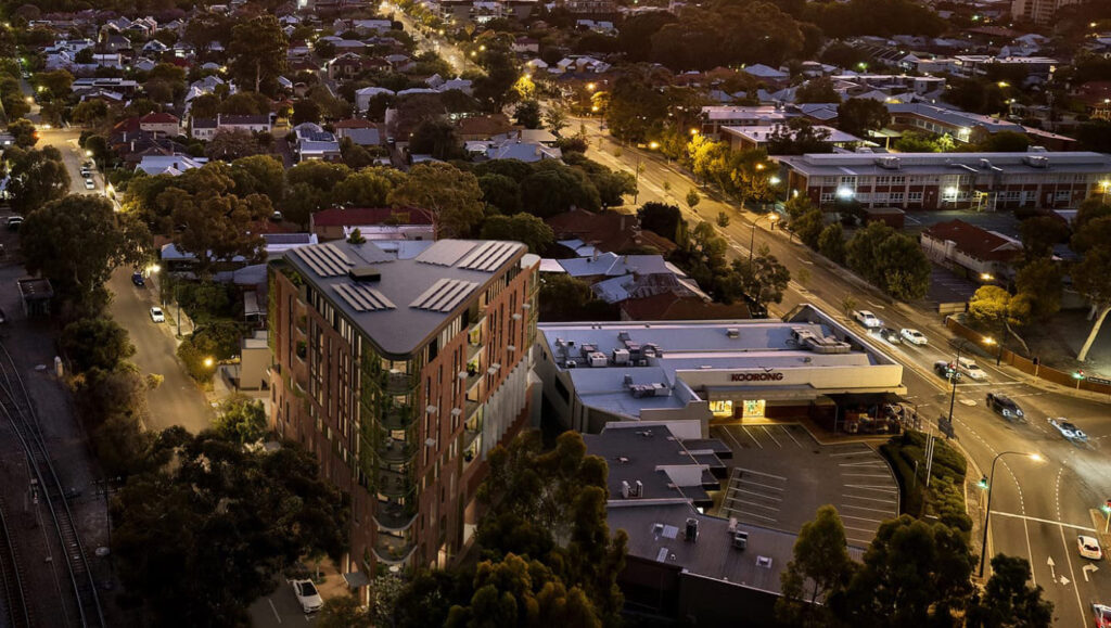 Aerial night view of apartment building with traffic and streetscape