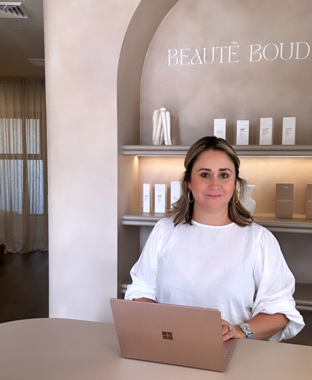 Anne-Eline Roberts on a laptop at the reception desk of Beaute Boudoir in Mt Lawley