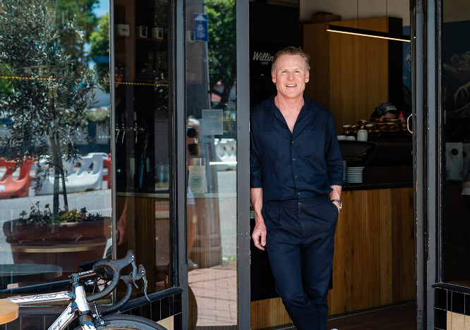 Photo of Tim Willing in doorway of Willing Coffee.