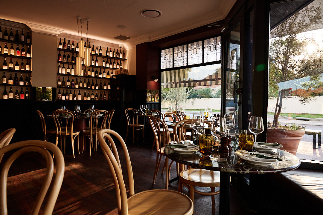 Interior of Bar Vino in Mount Lawley at dusk with empty wine glasses on tables ready for service